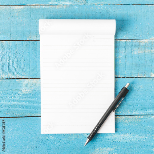 White line paper with pencil on blue wooden table
