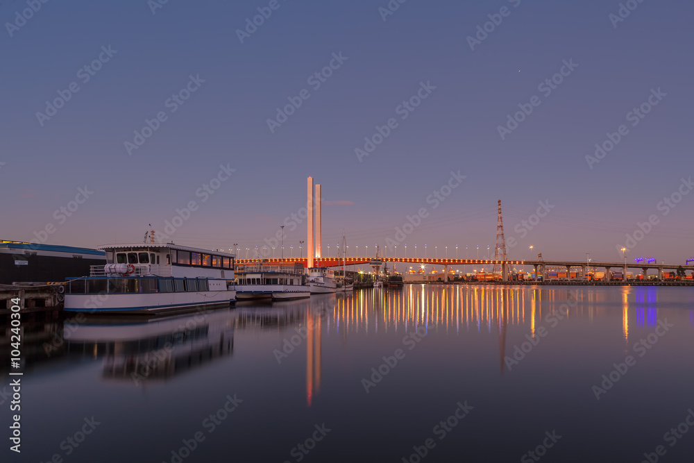 Bolte bridge, Melbourne with moored boats viewed from Docklands waterfront at dawn