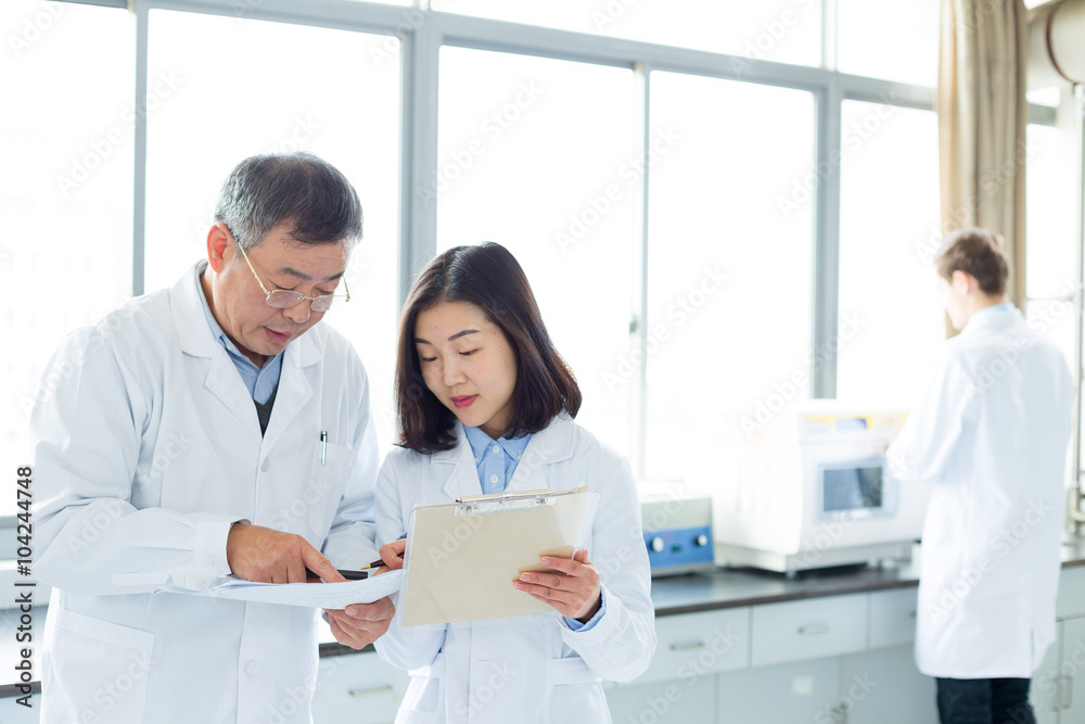 people doing chemical experiment in modern lab people doing chemical experiment in modern lab