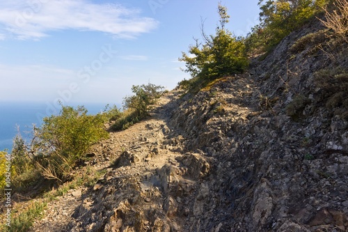 Mountain stone path. View on sea