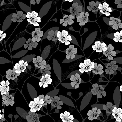 Seamless monochrome pattern with flowering branches on black background.