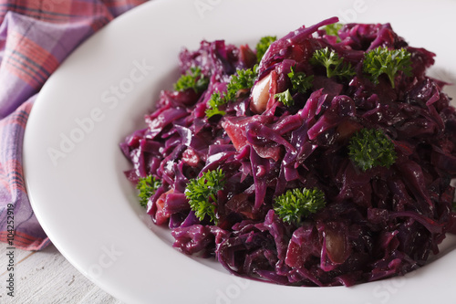 Braised red cabbage close-up on a plate. horizontal
