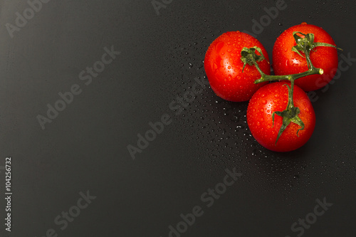 Twig tomatoes on a black background