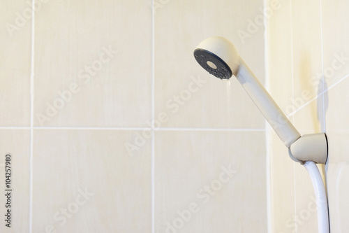 plastic shower head (Selected focus) with little water flows