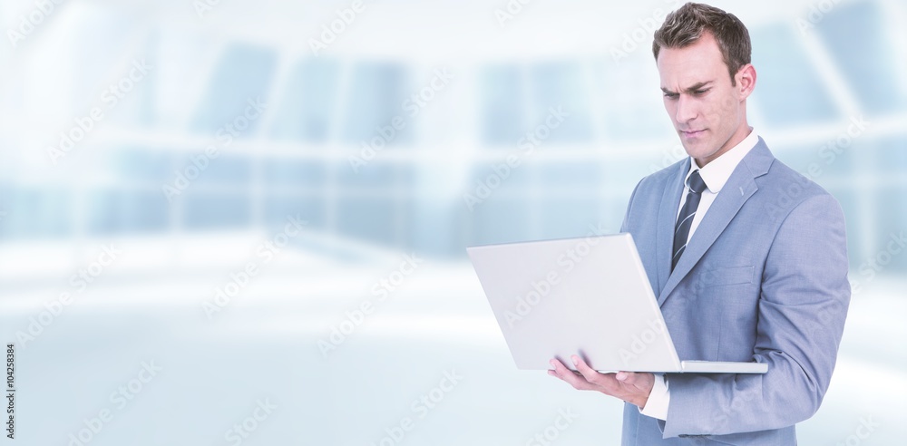 Composite image of businessman using laptop Composite image of businessman using laptop