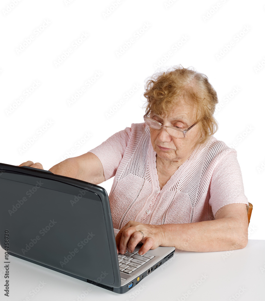 granny in glasses looks at the screen notebook on a white backgr granny in glasses looks at the screen notebook on a white backgr
