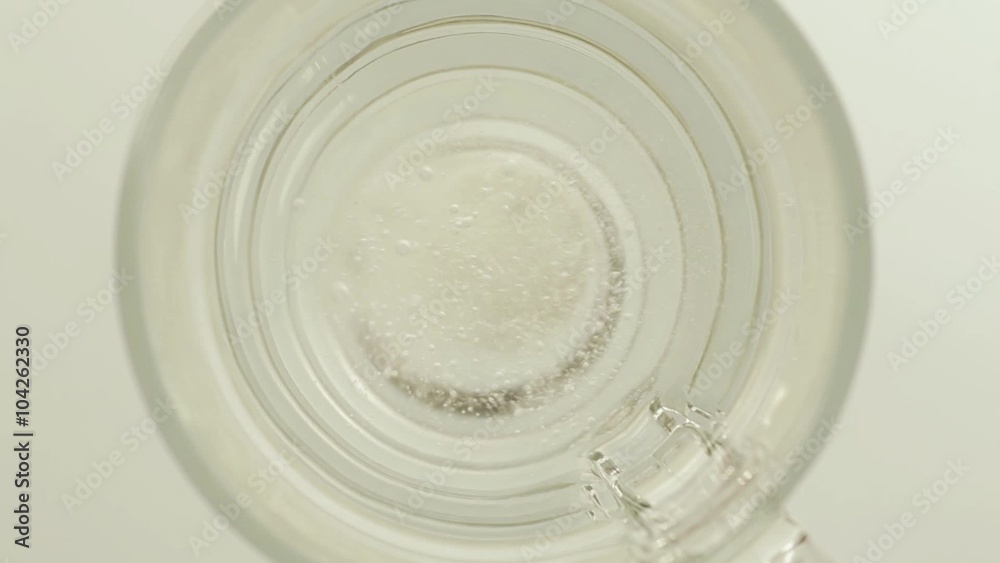 Soluble pill splashing into glass of water Soluble pill splashing into glass of water