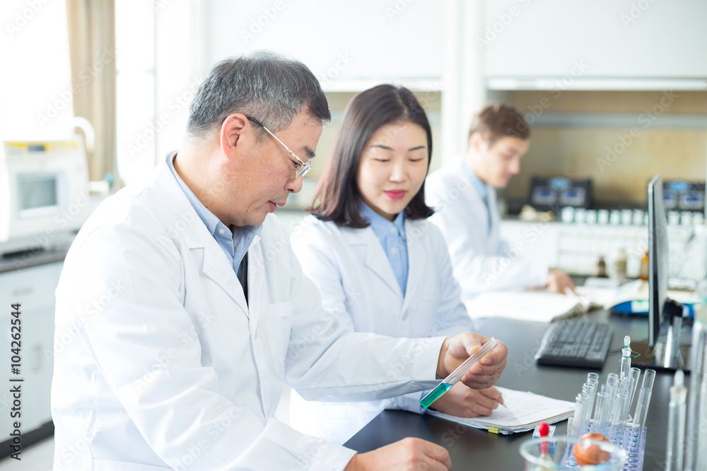 people doing chemical experiment in modern lab people doing chemical experiment in modern lab
