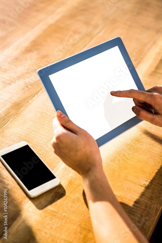 Over shoulder view of casual man using tablet photo