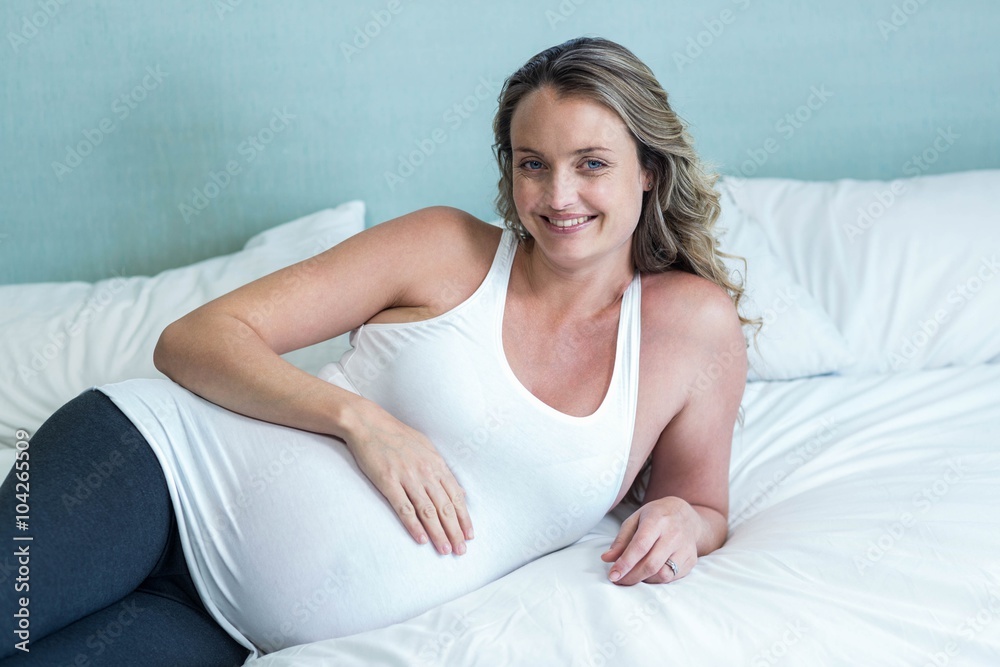 Pregnant woman touching her belly