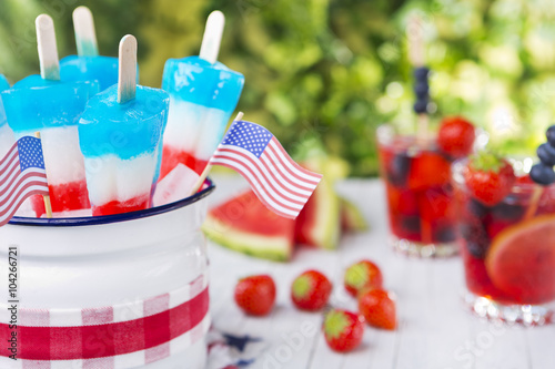 Red-white-and-blue popsicles on an outdoor table photo