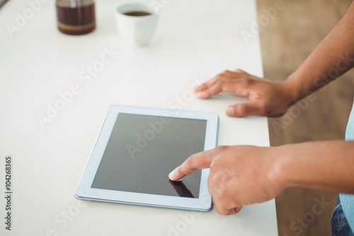 Close up of mans hands using tablet