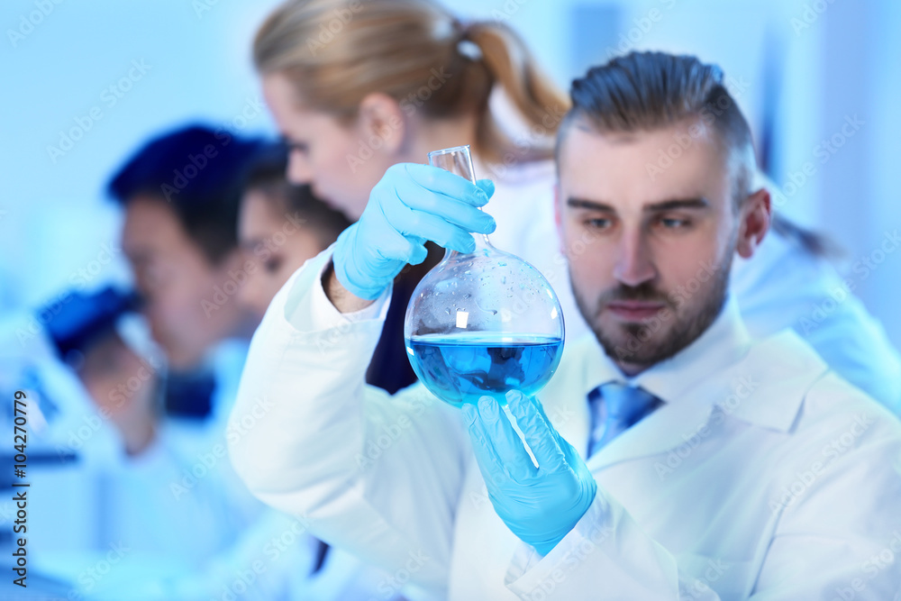 Young medical technicians working in laboratory Young medical technicians working in laboratory