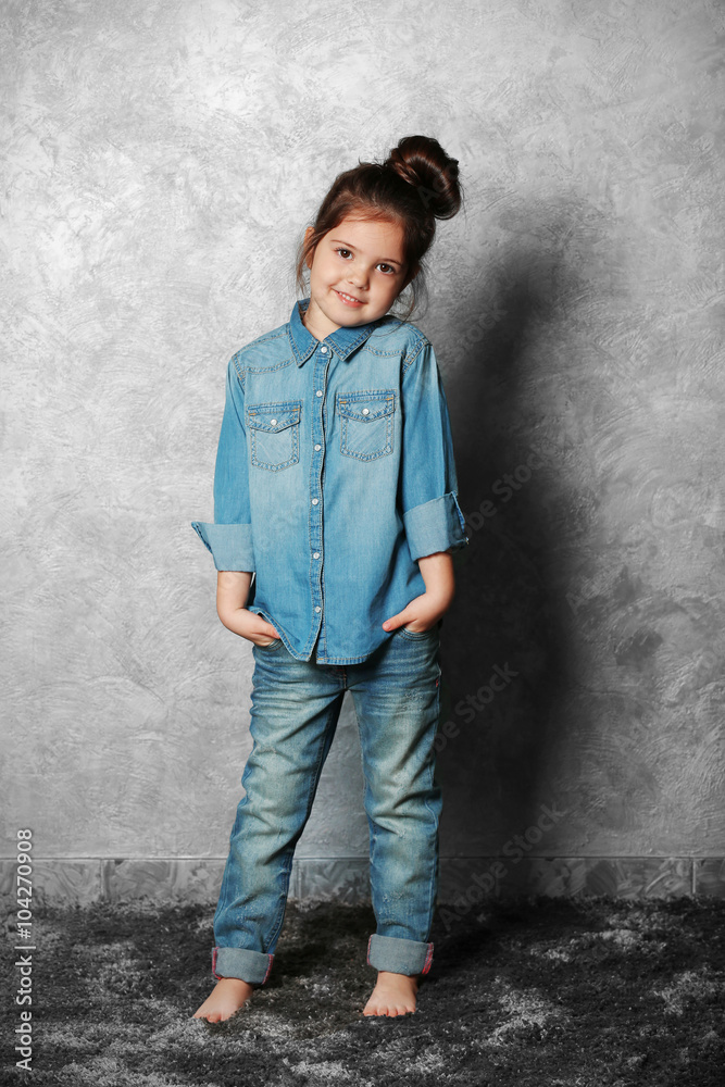Portrait of little fashion kid girl on gray wall background Portrait of little fashion kid girl on gray wall background