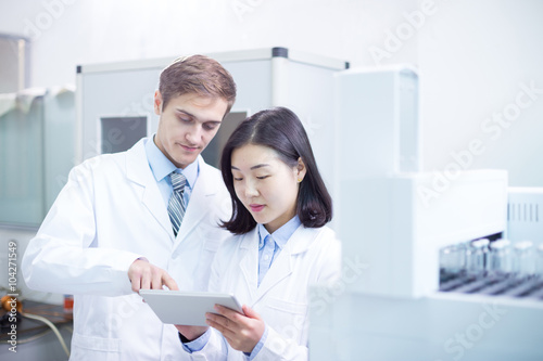 people analysis chemical experimental data with tablet