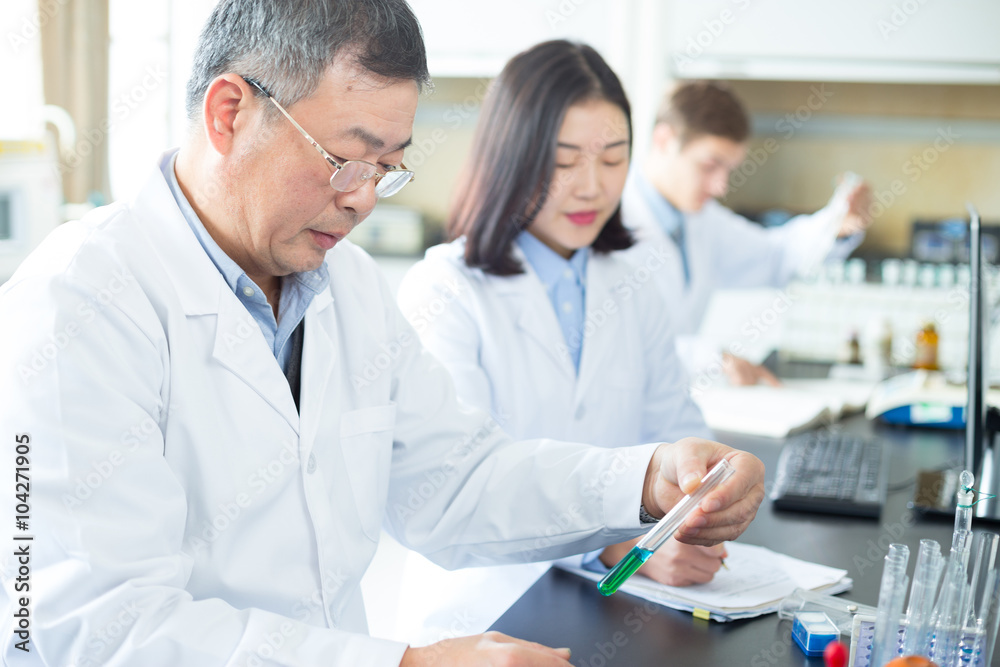 people doing chemical experiment in modern lab people doing chemical experiment in modern lab