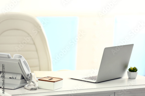 Workplace with laptop on the table © Africa Studio