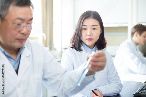 people doing chemical experiment in modern lab