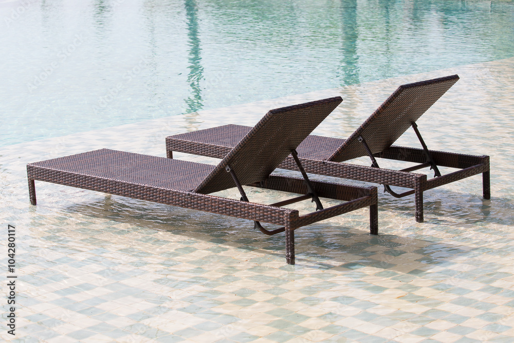 Fototapeta premium Swimming pool and two deck chairs, close up
