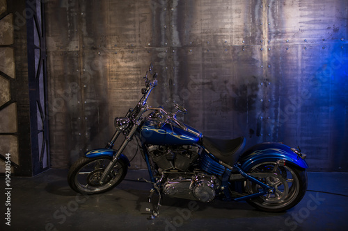 beautiful blue motorcycle on the background of vintage wall