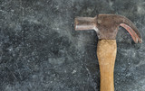 old used hammer on concrete texture floor background, top view with copy space