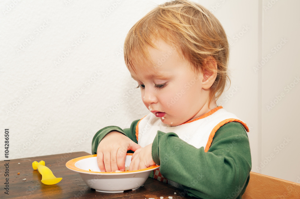 Adorable kid boy eating soup with his hands Adorable kid boy eating soup with his hands