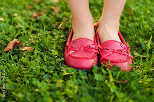 Close up of red moccasins on child's feet