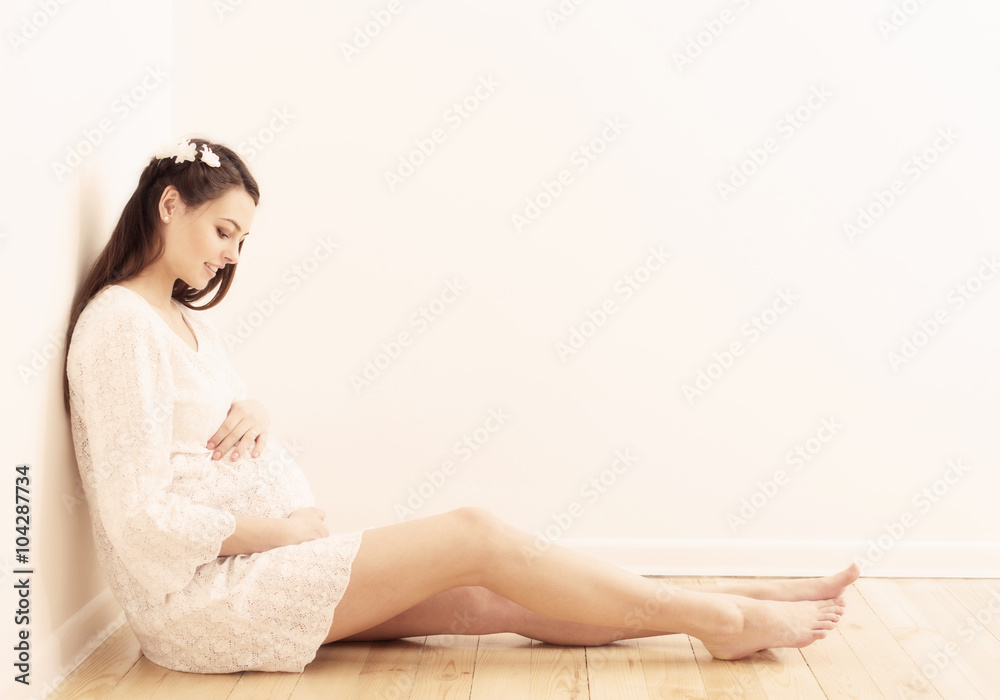 happy pregnant women sitting on the floor happy pregnant women sitting on the floor