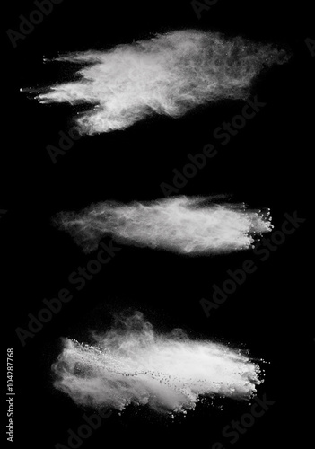 White powder explosion isolated on black background