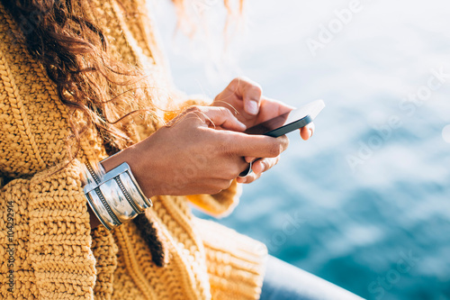 Young woman hands using phone