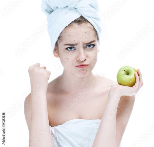 Girl with a pimply face holding apple. Woman skin care concept / photos of european girl on white background photo