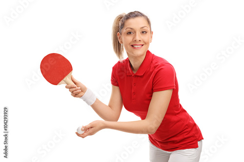 Joyful young woman playing table tennis
