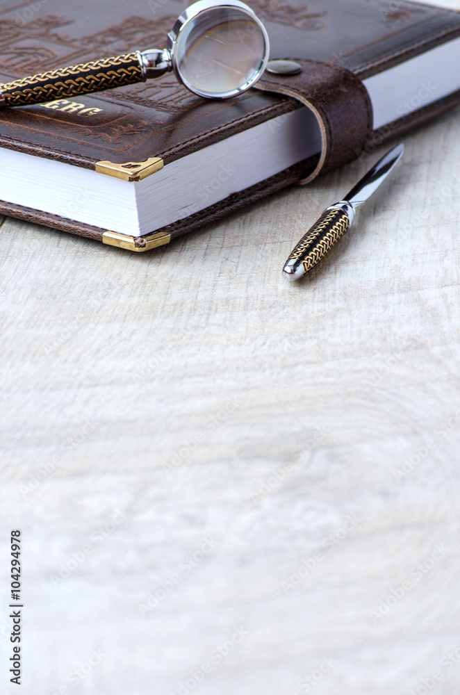 Stationery magnifying glass, paper knife and a notebook Stationery magnifying glass, paper knife and a notebook