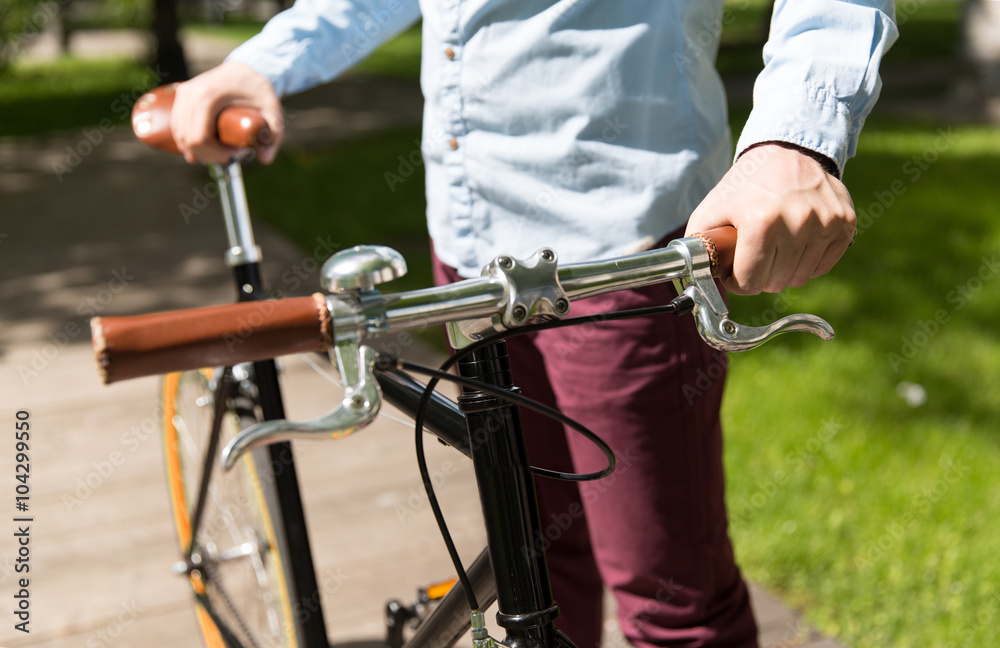 close up of young hipster man with fixed gear bike close up of young hipster man with fixed gear bike