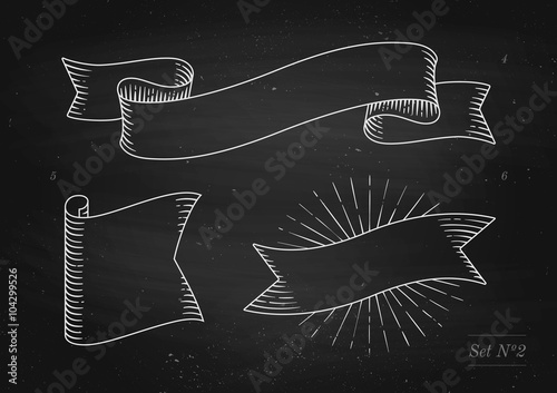 Set of old vintage ribbon banners in engraving style on a black chalkboard background and texture. Hand drawn design element. Vector illustration.