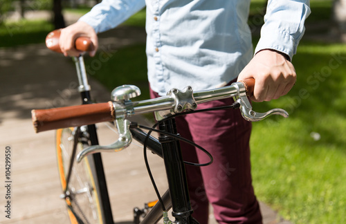 close up of young hipster man with fixed gear bike