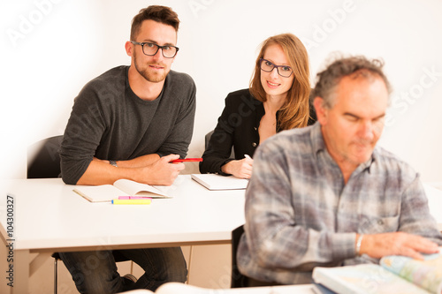 Group of people of different age sitting in classroom and attend