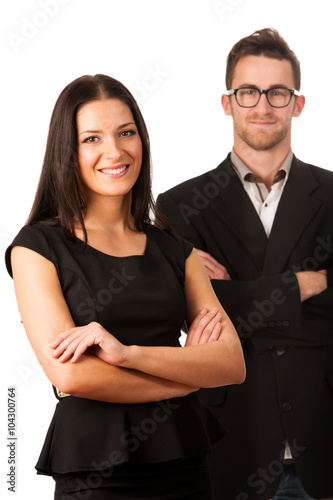 Confident business couple standing one behind the other as a sig