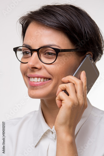 Attractive young business woman talks on her smartphone