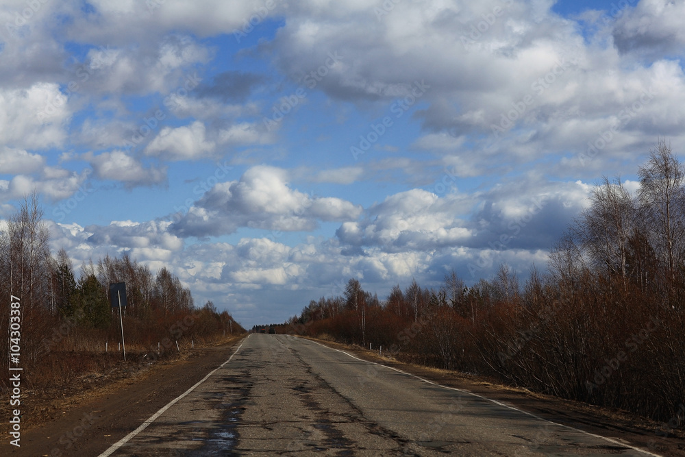 Autumn road and sky with clouds