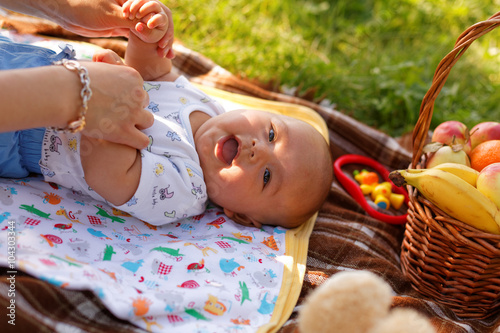 cute little baby boy with mother on picnic in the summer park