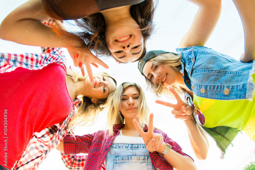 Obraz premium Group of attractive young women hugging in a circle - Four stude