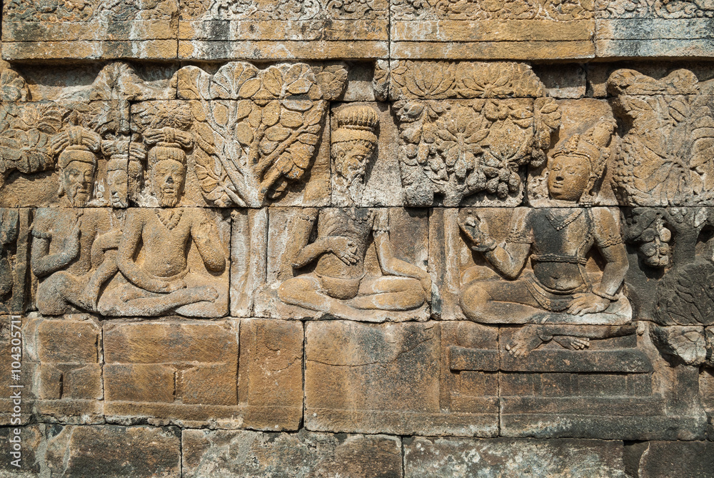 A sculpted relief panel at the Borobudur buddhist temple, a UNESCO World Heritage site in Central Java, Indonesia.