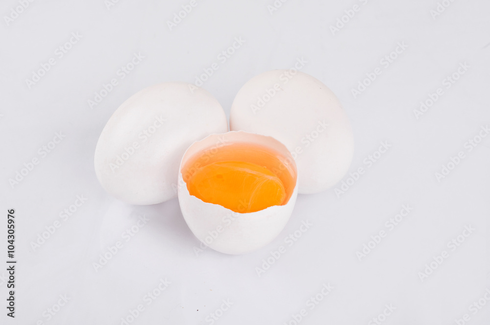 Whole and broken raw white eggs on white background Whole and broken raw white eggs on white background