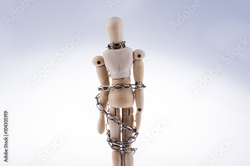 wooden model man in chains photo