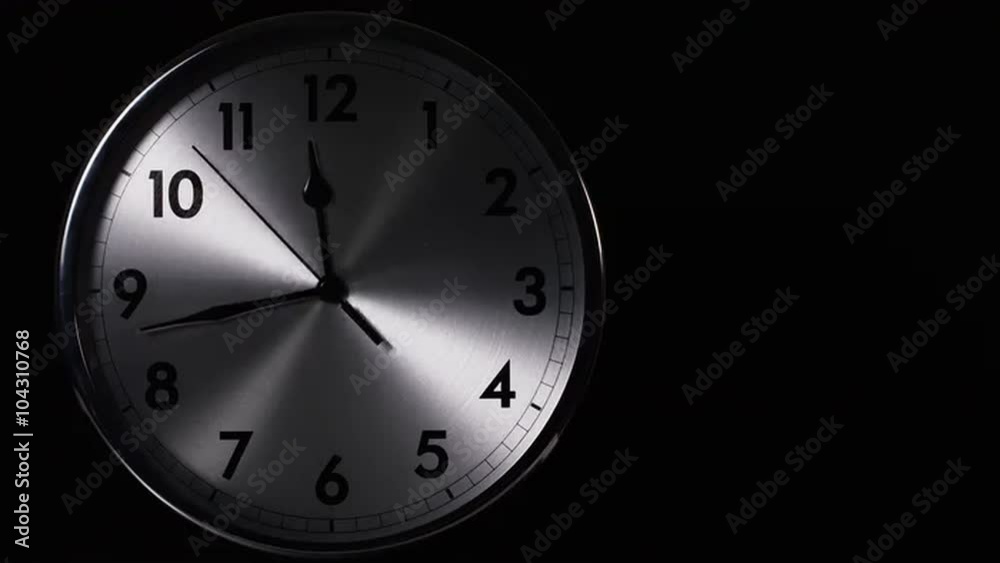 Time-lapse of a clock face with hands going up to 12 o'clock and beyond
