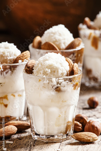 Dessert with vanilla ice cream, nut sauce, almonds, hazelnuts an
