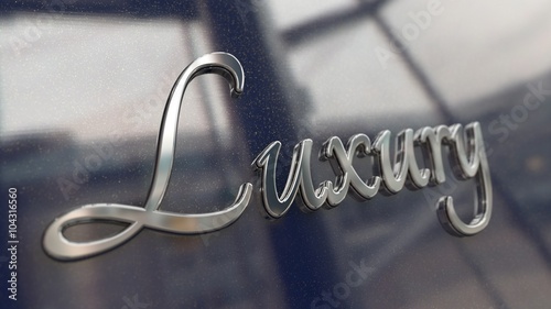 Chrome metal emblem with word Luxury written in script font on a glossy glittering surface. Render.
