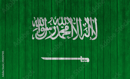 Saudi Arabia flag on wood texture background