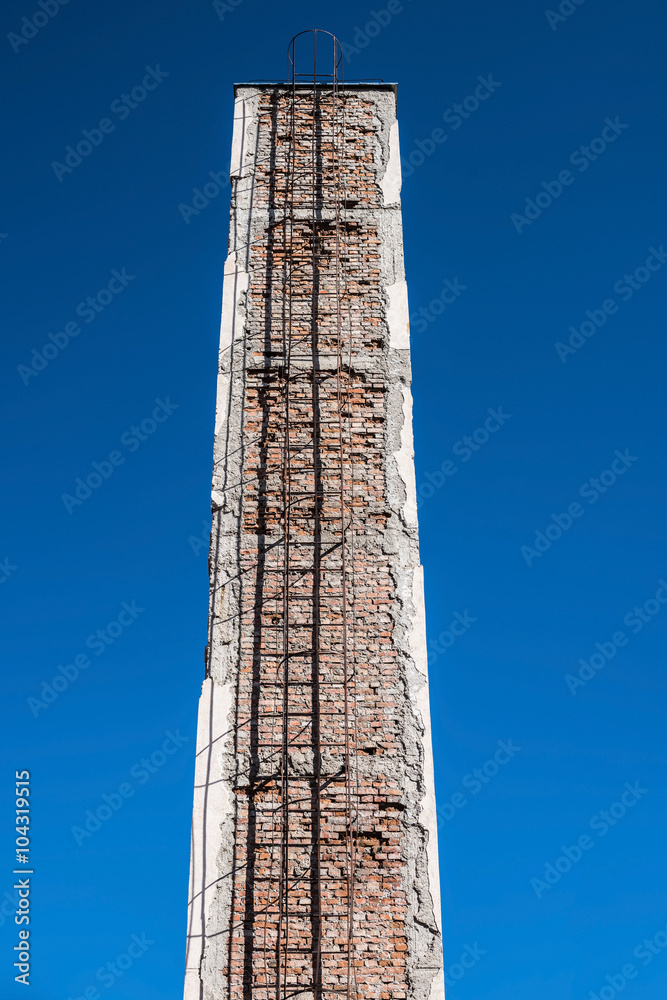 Chimney. Old brick industrial smokestack on sky background.